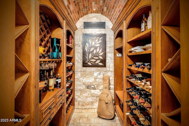 wine cellar featuring vaulted ceiling and brick ceiling