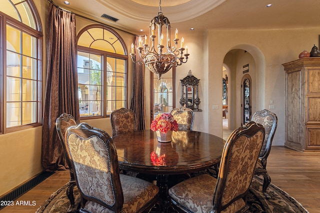 dining area featuring light hardwood / wood-style floors and a chandelier