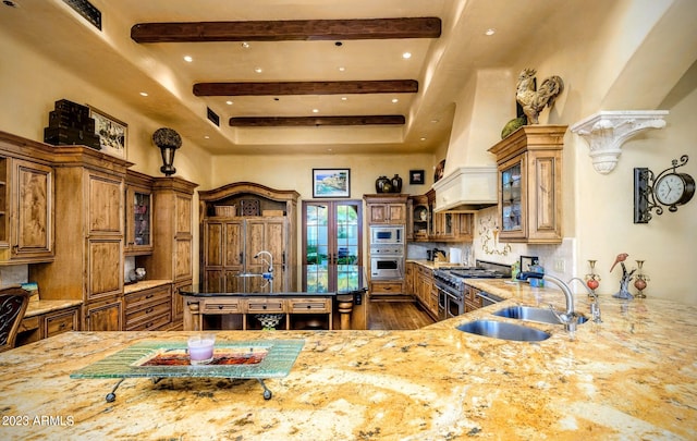 kitchen featuring tasteful backsplash, dark stone countertops, sink, and stainless steel appliances