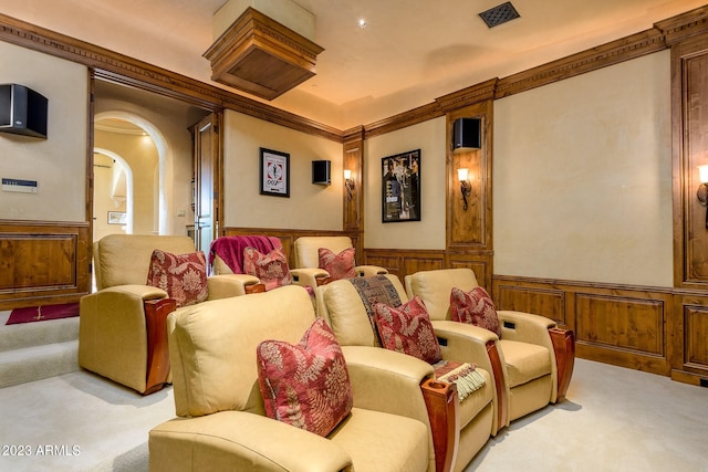 home theater with light colored carpet and crown molding