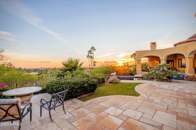 view of patio terrace at dusk