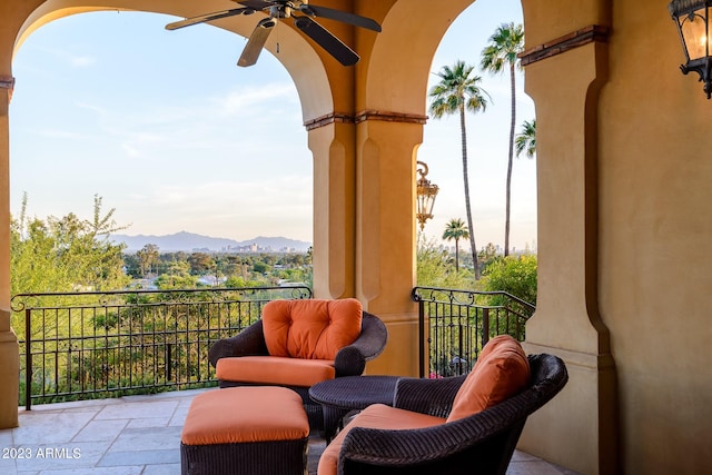 balcony with ceiling fan and a mountain view