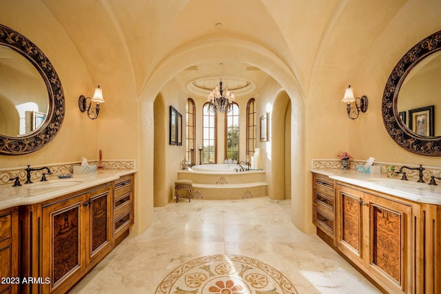 bathroom featuring a bathtub, vanity, and lofted ceiling