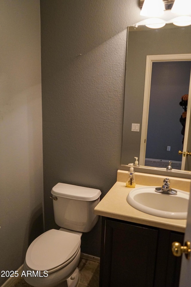 bathroom with tile patterned floors, vanity, and toilet