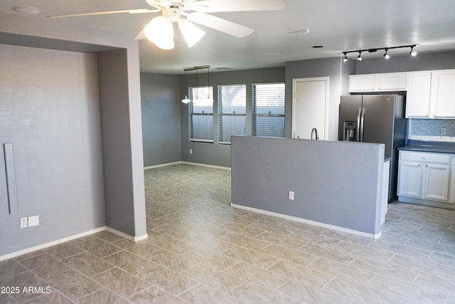 kitchen with white cabinets, decorative light fixtures, ceiling fan, and decorative backsplash