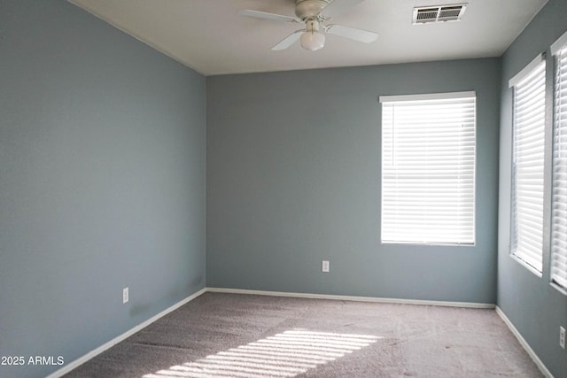 empty room with ceiling fan and light colored carpet