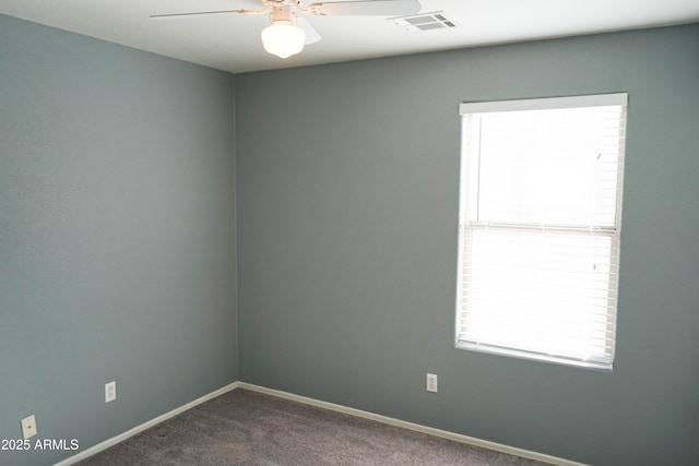 carpeted spare room featuring ceiling fan