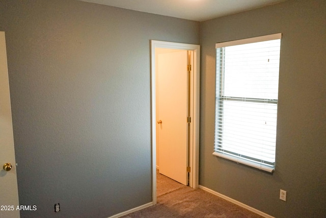 empty room with light colored carpet