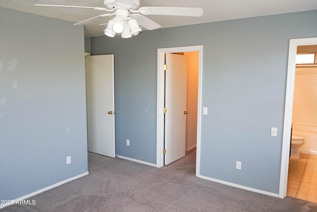 unfurnished bedroom with light colored carpet, ensuite bath, and ceiling fan