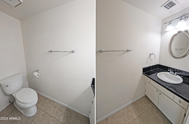 bathroom featuring tile patterned floors, vanity, and toilet