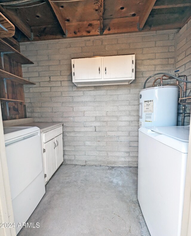 laundry room with cabinets and water heater