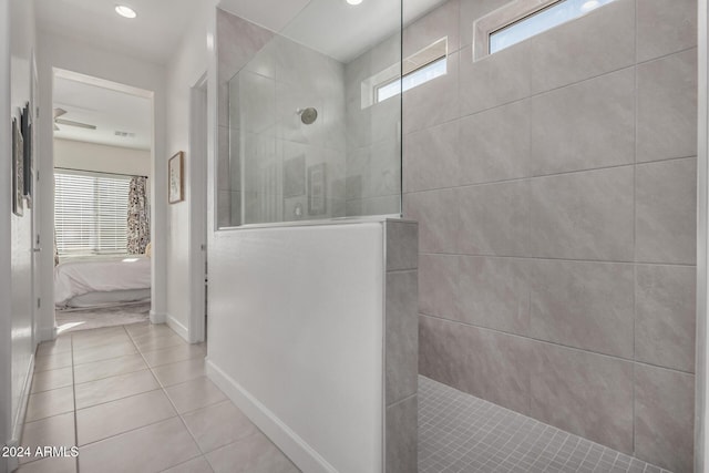 bathroom with tile patterned flooring and a tile shower