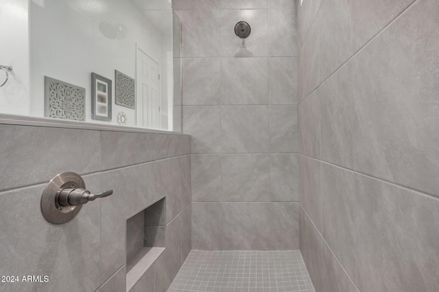 bathroom with tiled shower