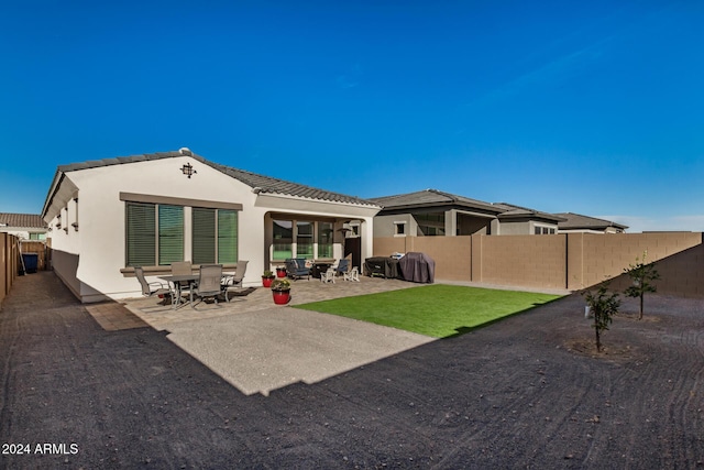 back of house with a patio