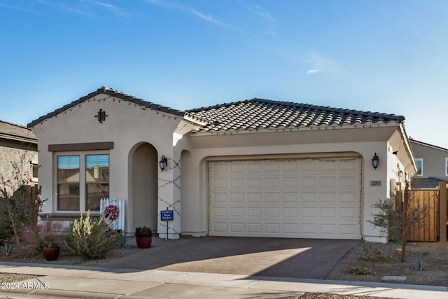 mediterranean / spanish home featuring a garage