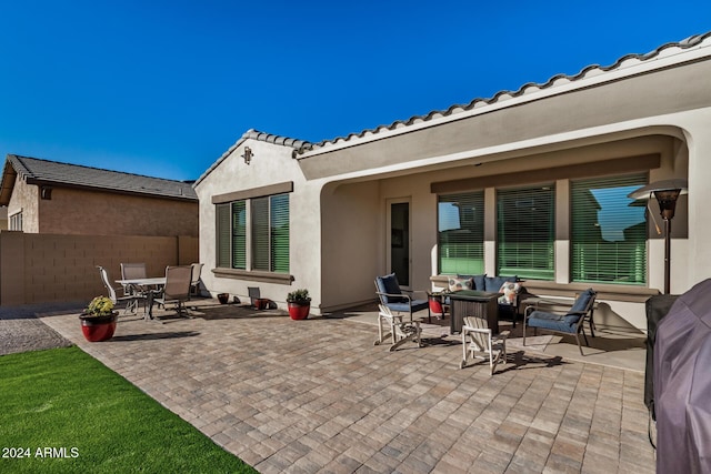 rear view of house featuring a patio area and outdoor lounge area