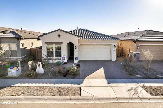 view of front of home with a garage and central air condition unit