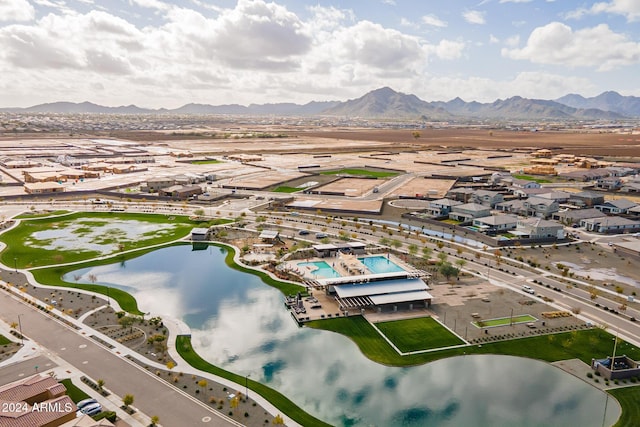 birds eye view of property with a water and mountain view