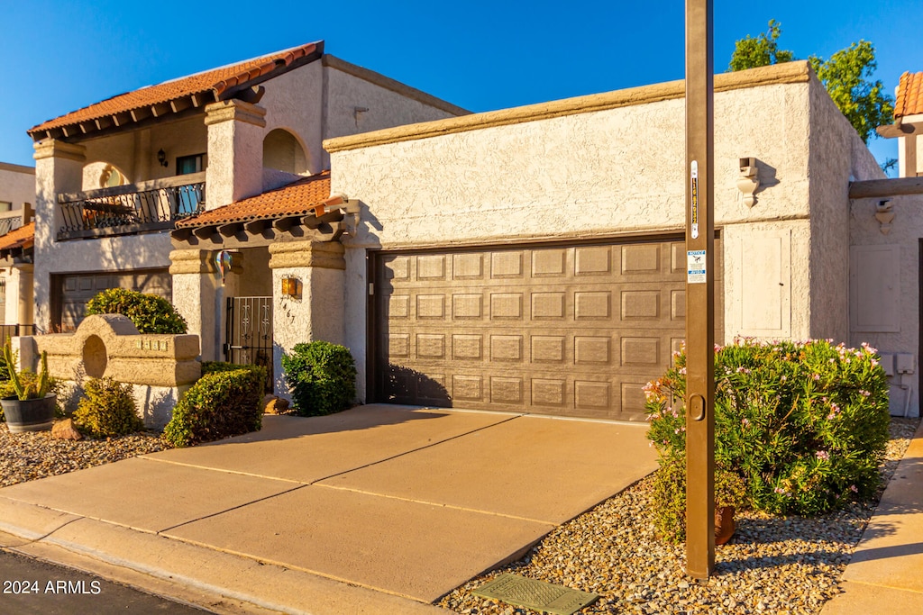 view of front of home with a balcony and a garage