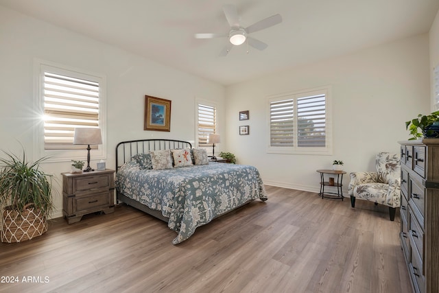 bedroom with ceiling fan and hardwood / wood-style flooring