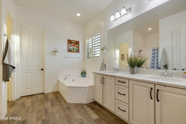 bathroom with shower with separate bathtub, vanity, and hardwood / wood-style flooring