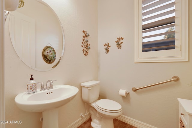 bathroom featuring hardwood / wood-style floors and toilet