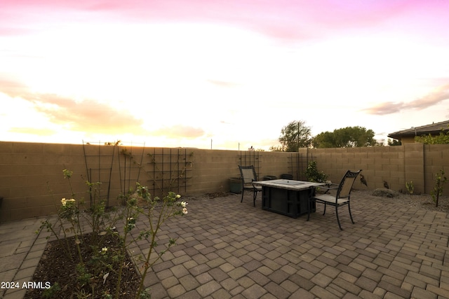 patio terrace at dusk featuring an outdoor fire pit