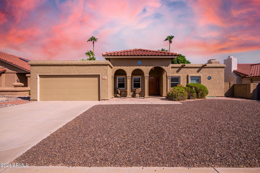 mediterranean / spanish house with a garage