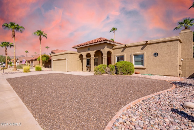 mediterranean / spanish-style home featuring a garage