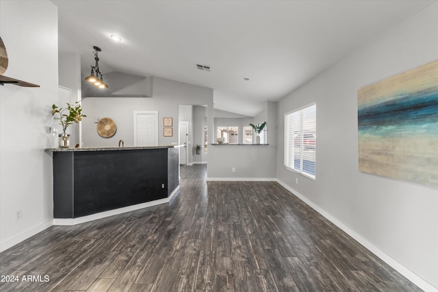 unfurnished living room with dark hardwood / wood-style floors and vaulted ceiling