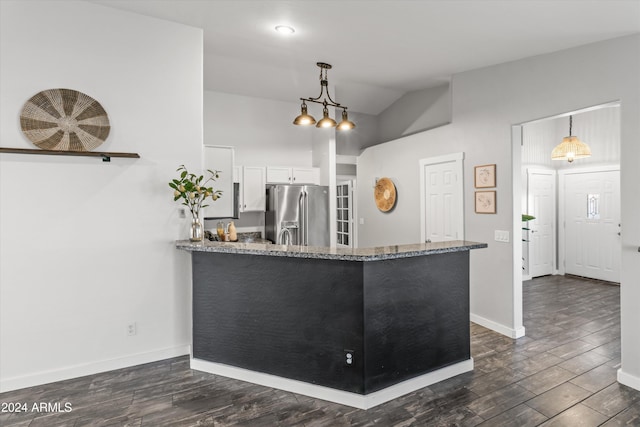 kitchen with kitchen peninsula, white cabinetry, stainless steel refrigerator with ice dispenser, and hanging light fixtures