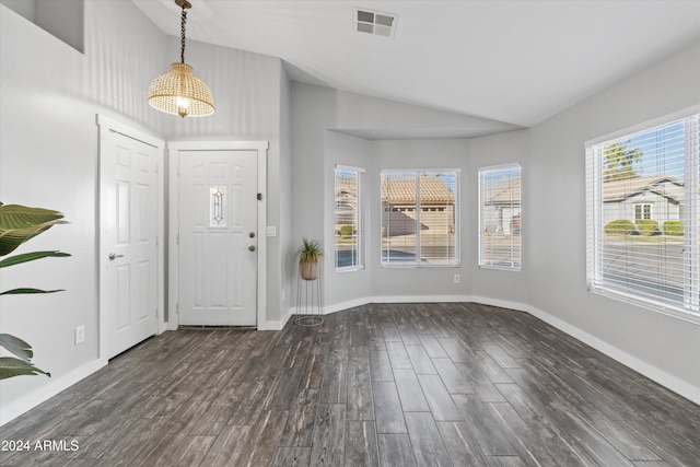 foyer entrance with dark hardwood / wood-style flooring and vaulted ceiling