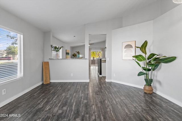 unfurnished living room with vaulted ceiling and dark hardwood / wood-style floors