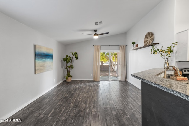 interior space with vaulted ceiling, ceiling fan, and dark wood-type flooring