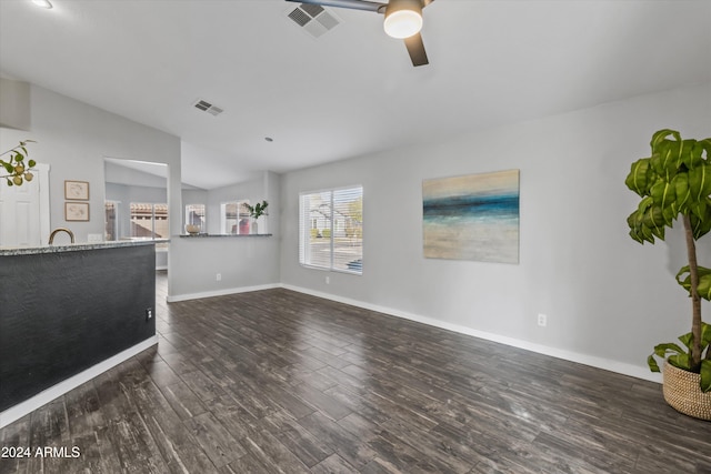 unfurnished living room featuring ceiling fan, dark hardwood / wood-style flooring, and lofted ceiling