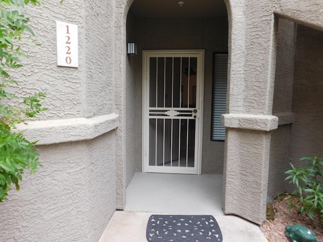 entrance to property with stucco siding