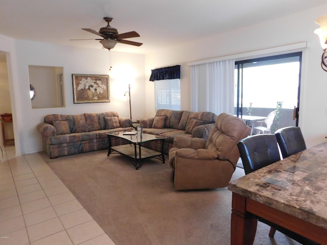 carpeted living room with tile patterned floors and a ceiling fan