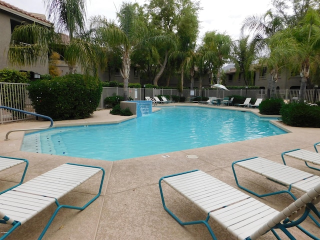 community pool featuring a patio area and fence