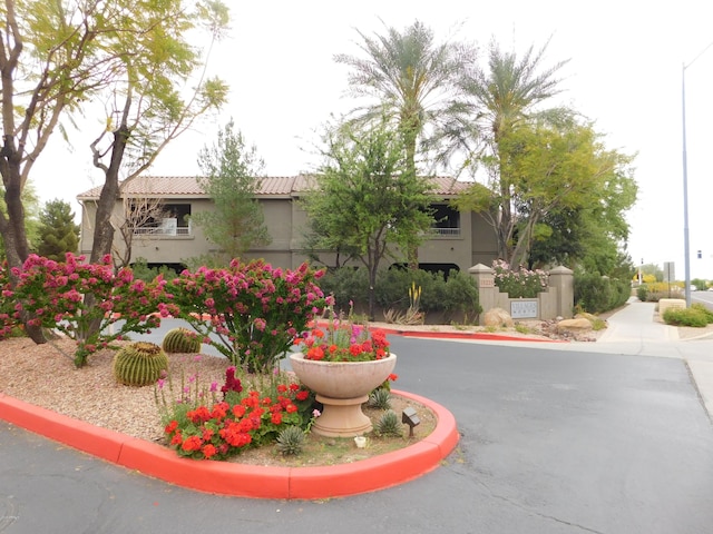 exterior space featuring stucco siding and a tiled roof