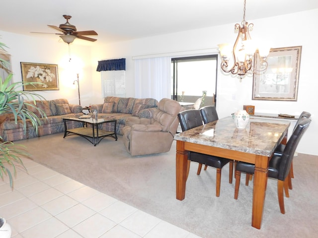 dining area with light carpet, ceiling fan with notable chandelier, and light tile patterned flooring