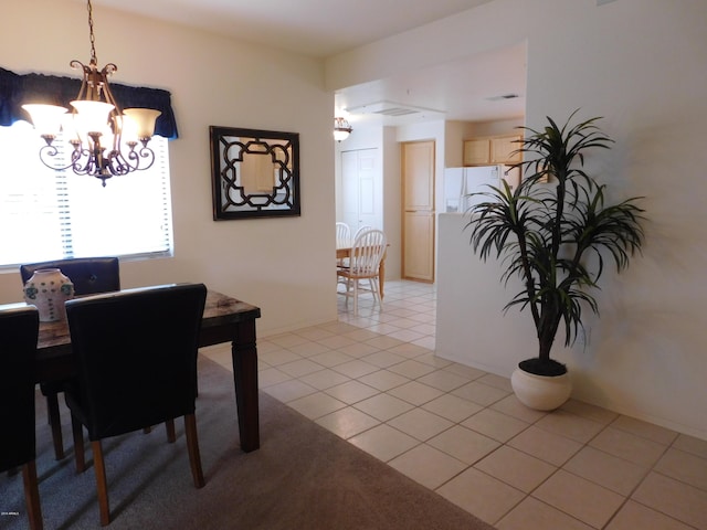 dining area with an inviting chandelier and light tile patterned flooring