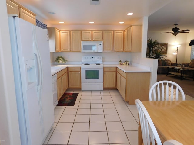 kitchen featuring white appliances, light brown cabinets, light tile patterned flooring, light countertops, and open floor plan