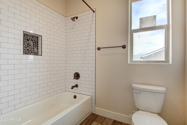 bathroom featuring toilet, tiled shower / bath, and hardwood / wood-style flooring