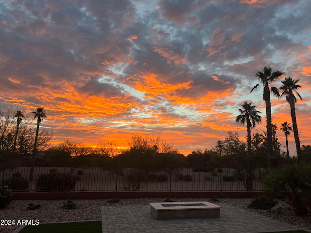 pool at dusk with a fire pit