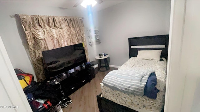 bedroom featuring hardwood / wood-style flooring and ceiling fan