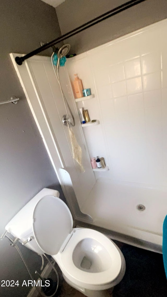 bathroom with toilet and walk in shower