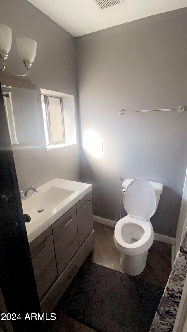 bathroom featuring vanity and toilet