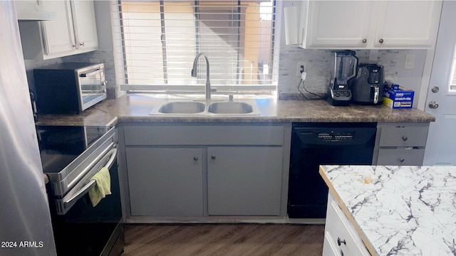 kitchen featuring dishwasher, white cabinetry, sink, and dark wood-type flooring