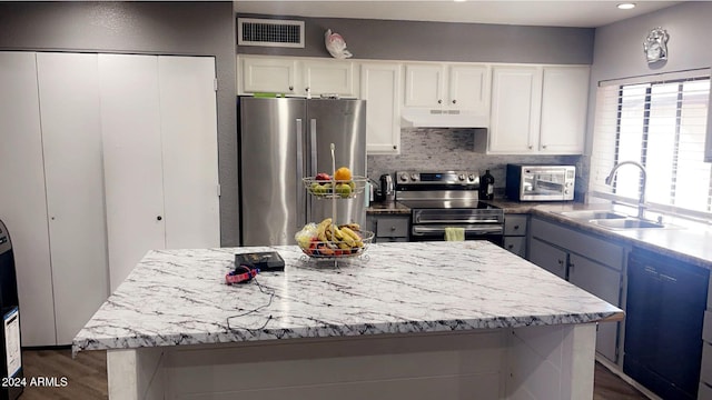 kitchen featuring white cabinets, stainless steel appliances, dark hardwood / wood-style floors, and sink