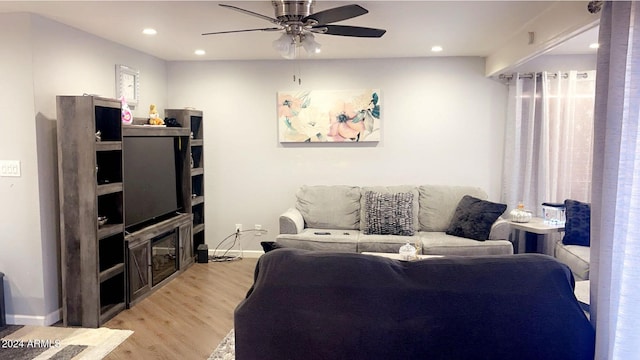 living room with ceiling fan and light wood-type flooring